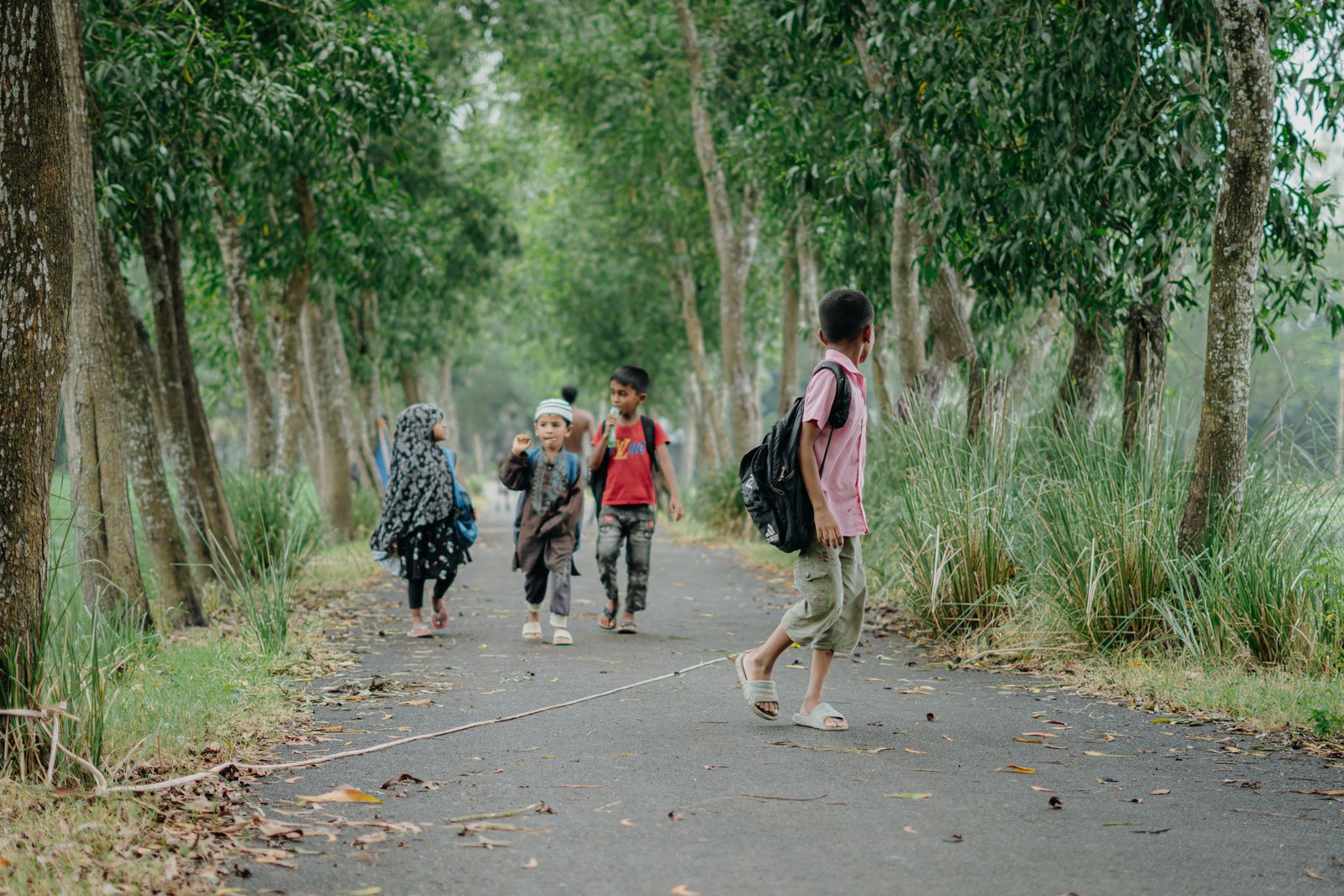 Children walking to school on a bright morning