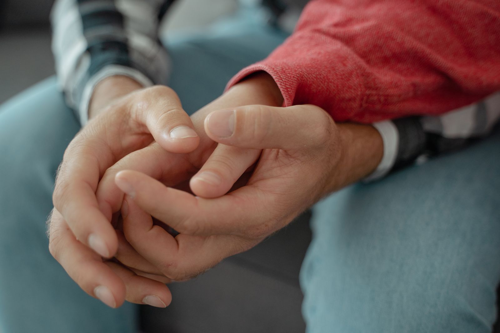 One person offering a reassuring hand to another